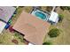 Aerial shot of a home's brown roof and the inviting blue swimming pool beyond at 3080 Saint James St, Port Charlotte, FL 33952