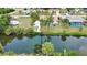 Aerial view of the home features a waterway, pool, screened-in lanai, lush vegetation, and RV parking at 3080 Saint James St, Port Charlotte, FL 33952