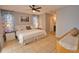 This main bedroom features a ceiling fan, tile floors, a comfortable bed, and lots of natural light at 3080 Saint James St, Port Charlotte, FL 33952