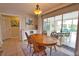 Charming dining area offering a view of the pool and access to adjacent rooms at 3080 Saint James St, Port Charlotte, FL 33952