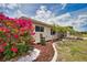 Attractive home featuring colorful landscaping, a spacious driveway, and an attached two car garage at 3080 Saint James St, Port Charlotte, FL 33952