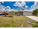 Inviting home featuring a spacious driveway, well maintained landscaping, and a convenient two-car garage at 3080 Saint James St, Port Charlotte, FL 33952