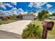 Beautiful home featuring a well-manicured lawn, landscaping, and a convenient two-car garage for easy parking at 3080 Saint James St, Port Charlotte, FL 33952