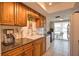 This kitchen features tile floors and backsplash, wood cabinets, and stainless steel faucet and sink at 3080 Saint James St, Port Charlotte, FL 33952