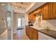 This kitchen offers tile flooring, white backsplash, wood cabinets, and white appliances at 3080 Saint James St, Port Charlotte, FL 33952
