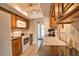 This kitchen includes wooden cabinets, white appliances, tile flooring, and black countertops at 3080 Saint James St, Port Charlotte, FL 33952