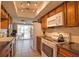 This kitchen offers white appliances, tile flooring, dark countertops, and wood cabinets at 3080 Saint James St, Port Charlotte, FL 33952
