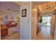 Inviting living room with tile floors, tan leather couches, and seamless access to the kitchen at 3080 Saint James St, Port Charlotte, FL 33952