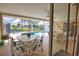 Covered patio featuring comfortable seating and views of the inviting backyard pool at 3080 Saint James St, Port Charlotte, FL 33952