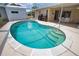 Screened-in pool with steps into the water and a spacious patio area, perfect for outdoor entertaining at 3080 Saint James St, Port Charlotte, FL 33952