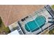 Aerial view showcasing a screened-in pool with clear blue water and outdoor seating at 3080 Saint James St, Port Charlotte, FL 33952