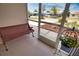 Relax on this screened-in porch with a lovely bench seat and potted plants. Enjoy the views! at 3080 Saint James St, Port Charlotte, FL 33952