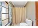 Bathroom with a shower, neutral color walls, and a decorative window with floral curtains at 3663 Sterling Rd, Venice, FL 34293