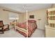 Cozy bedroom featuring a four-poster bed, a window, and classic decor, creating a warm and inviting space at 3663 Sterling Rd, Venice, FL 34293