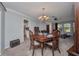 Dining room with neutral walls and carpeting, adjacent to kitchen area at 3663 Sterling Rd, Venice, FL 34293