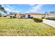 Single-story home featuring a well-manicured lawn and landscaping at 3663 Sterling Rd, Venice, FL 34293