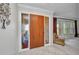 Foyer area featuring tile flooring and a wooden front door with sidelights at 3663 Sterling Rd, Venice, FL 34293
