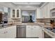 Open-concept kitchen with white cabinetry, stainless steel appliances and view to living room at 3663 Sterling Rd, Venice, FL 34293
