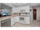 Bright kitchen featuring white cabinetry, tile backsplash, and modern appliances at 3663 Sterling Rd, Venice, FL 34293