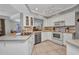 Well-lit kitchen with white cabinetry, stainless steel appliances, tile floor and modern fixtures at 3663 Sterling Rd, Venice, FL 34293