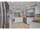 Modern kitchen featuring white cabinets, tile flooring, stainless steel dishwasher and view to the back at 3663 Sterling Rd, Venice, FL 34293