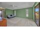 Spacious living room with a ceiling fan, carpeted floor, and sliding glass doors leading to the outside at 3663 Sterling Rd, Venice, FL 34293