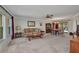 Open living room and dining area with neutral carpet and natural light at 3663 Sterling Rd, Venice, FL 34293