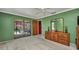 Spacious main bedroom with sliding glass doors to the pool, dresser, and an ensuite bathroom entrance at 3663 Sterling Rd, Venice, FL 34293