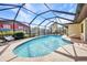 Inviting in-ground pool surrounded by a screened enclosure, perfect for swimming and outdoor enjoyment at 3663 Sterling Rd, Venice, FL 34293