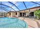 Inviting screened-in pool area featuring a sparkling pool, covered patio and outdoor seating, perfect for relaxation and entertainment at 3663 Sterling Rd, Venice, FL 34293