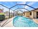 Inviting in-ground pool surrounded by a screened enclosure, perfect for swimming and outdoor enjoyment at 3663 Sterling Rd, Venice, FL 34293
