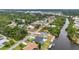 Aerial view of a residential neighborhood with waterfront homes and canals winding through lush greenery at 474 Lomond Dr, Port Charlotte, FL 33953