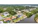 The aerial image showcases houses with private boat docks lining the canal, with dense trees nearby at 474 Lomond Dr, Port Charlotte, FL 33953