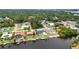 Overhead shot of waterfront houses along a canal, featuring private docks and green lawns at 474 Lomond Dr, Port Charlotte, FL 33953