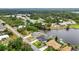 Wide aerial view of homes located on a canal, featuring mature landscaping and private boat docks at 474 Lomond Dr, Port Charlotte, FL 33953