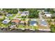 Aerial view of waterfront homes with pools along a canal, featuring boat docks and manicured lawns at 474 Lomond Dr, Port Charlotte, FL 33953