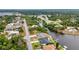 A wide-angle aerial photograph showcasing homes bordering the canal surrounded by palm trees at 474 Lomond Dr, Port Charlotte, FL 33953