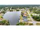 Scenic aerial view of waterfront homes along a canal, boasting lush greenery and neighborhood charm at 474 Lomond Dr, Port Charlotte, FL 33953