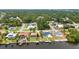 Scenic aerial view of waterfront homes with pools along a canal, featuring boat docks and mature landscaping at 474 Lomond Dr, Port Charlotte, FL 33953