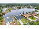 Scenic aerial view of homes along a wide canal, featuring manicured lawns and private boat docks at 474 Lomond Dr, Port Charlotte, FL 33953