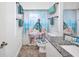 Bright bathroom featuring granite counters, a decorative mirror, and a unique 'get naked' themed shower curtain at 474 Lomond Dr, Port Charlotte, FL 33953