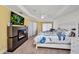 Comfortable bedroom with fireplace, tv, neutral colors and lots of natural light at 474 Lomond Dr, Port Charlotte, FL 33953