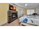 Cozy bedroom with a decorative fireplace, mounted TV, and beach-themed decor at 474 Lomond Dr, Port Charlotte, FL 33953