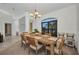 Dining area with a rustic table, seating, and a view of the tropical landscaping at 474 Lomond Dr, Port Charlotte, FL 33953