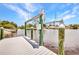 A waterfront dock showcases a boat lift surrounded by water, under a stunning, partly cloudy sky at 474 Lomond Dr, Port Charlotte, FL 33953