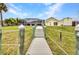 The wooden dock leads to a screened enclosure with beautiful waterfront views at 474 Lomond Dr, Port Charlotte, FL 33953
