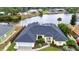 Charming yellow home featuring a well-manicured lawn, attached garage, and a welcoming entryway, blending comfort with curb appeal at 474 Lomond Dr, Port Charlotte, FL 33953