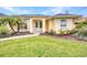 Close-up of the home's entrance, highlighting the well-manicured landscaping and inviting double doors at 474 Lomond Dr, Port Charlotte, FL 33953