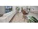 View of open concept kitchen and bar with neutral granite countertops, white couch and a view to the outside pool at 474 Lomond Dr, Port Charlotte, FL 33953