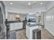 Modern kitchen with granite counters, stainless appliances, an island, and tiled floors at 474 Lomond Dr, Port Charlotte, FL 33953